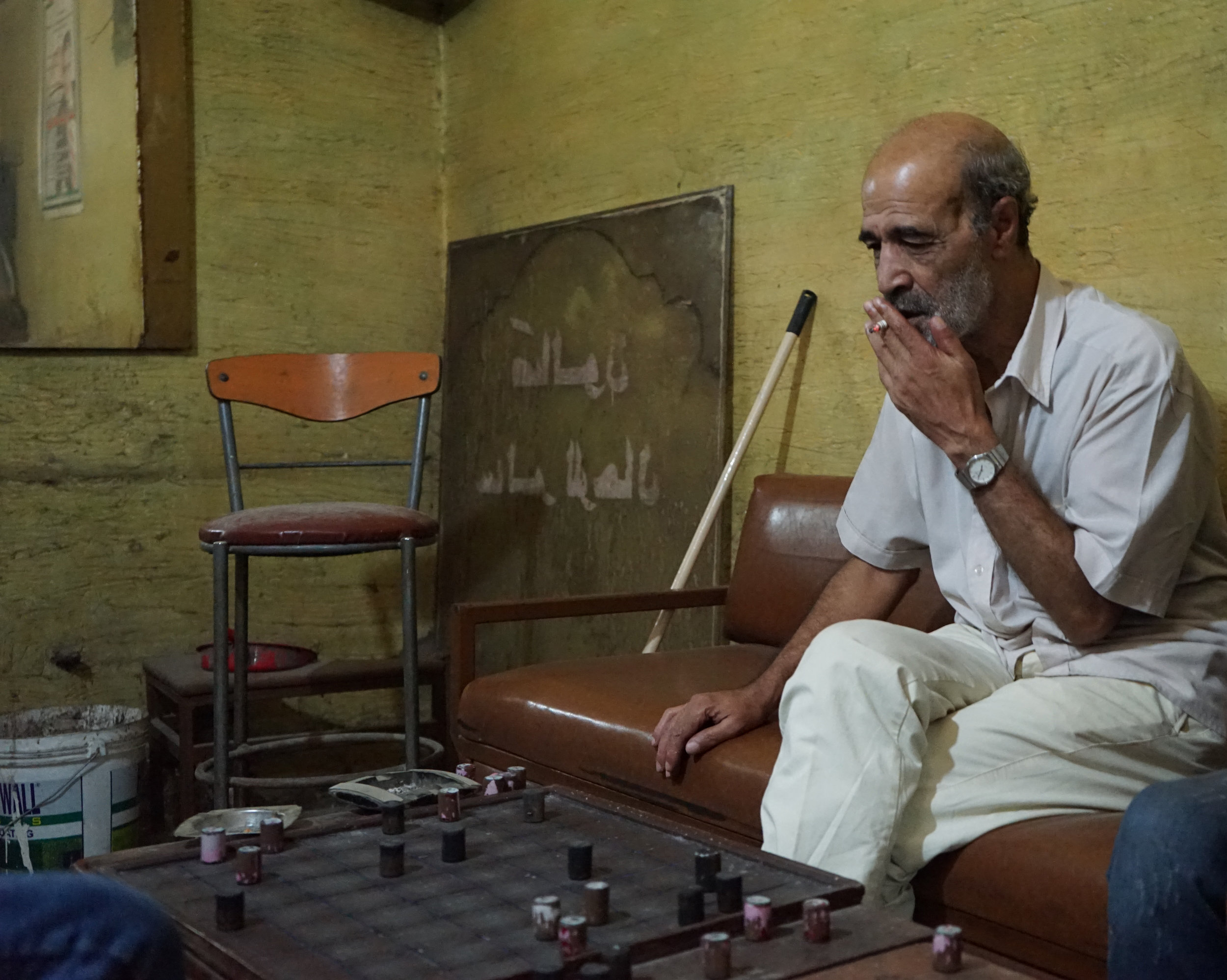  A man deliberates his next move during a game of chess in Camp Beddawi on August 20, 2016. 