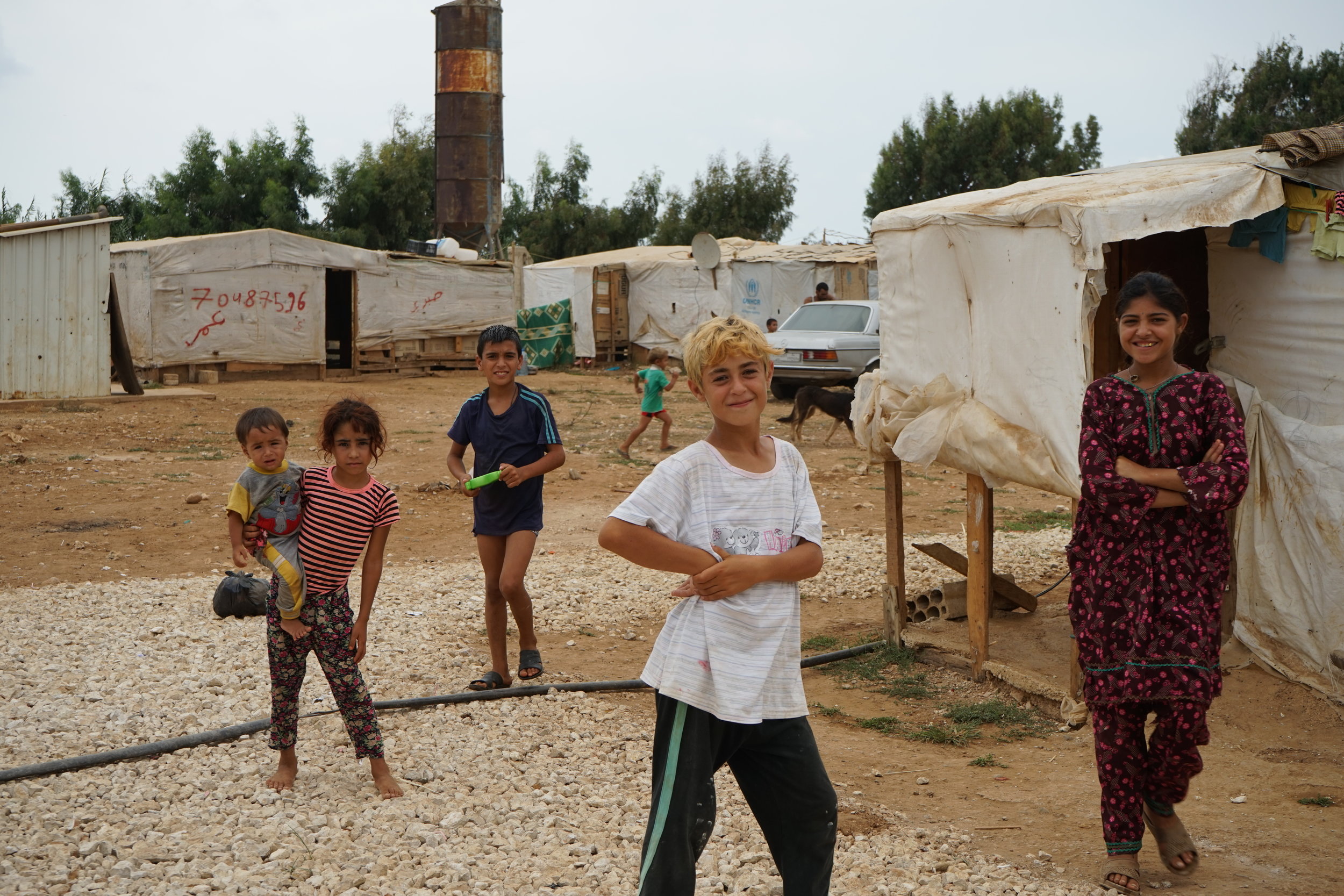  Children stand in UNHCR Syrian refugee camp 054 in 'Akkar on August 24, 2016. 