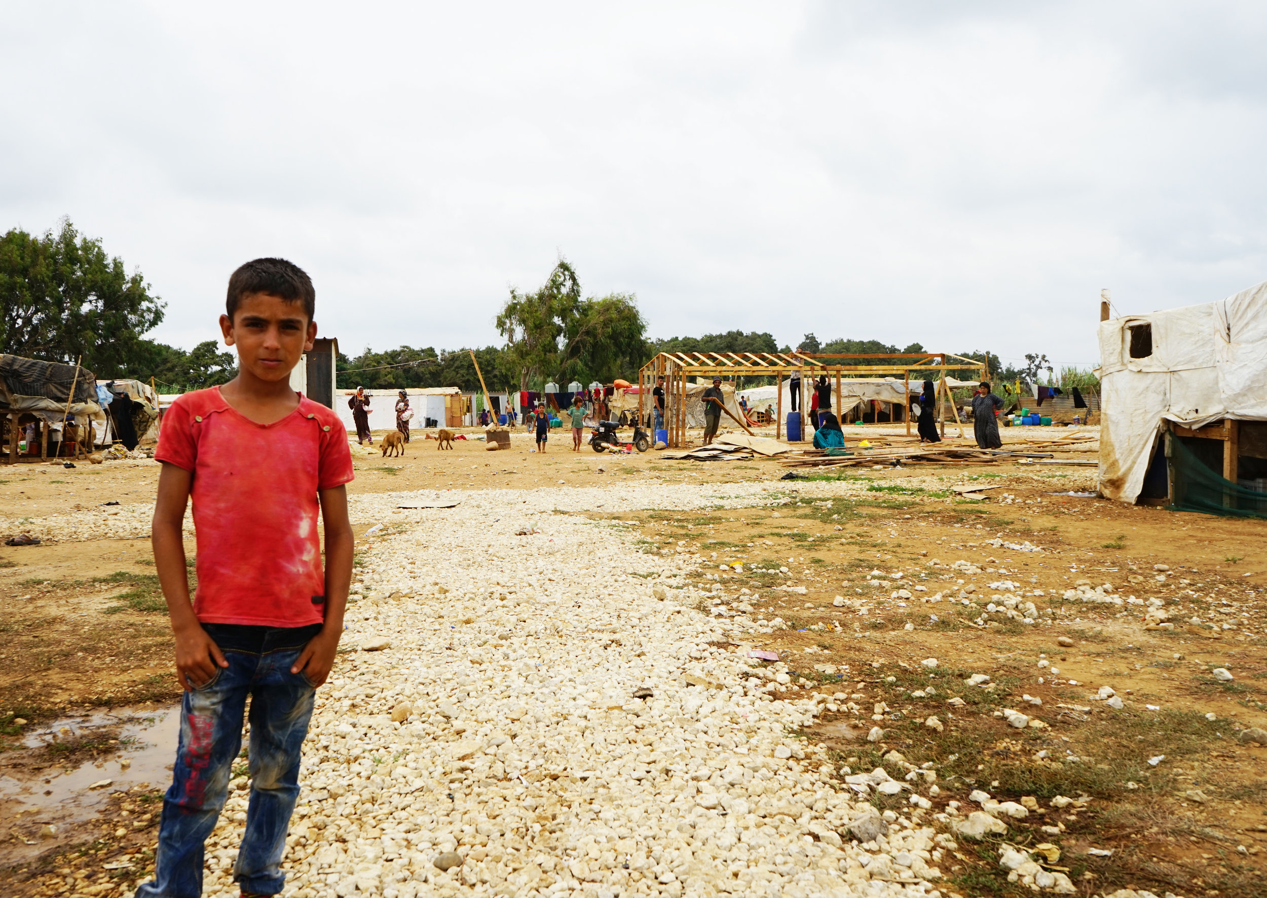  A boy stands in UNHCR Syrian refugee camp 054 in 'Akkar on August 24, 2016. 