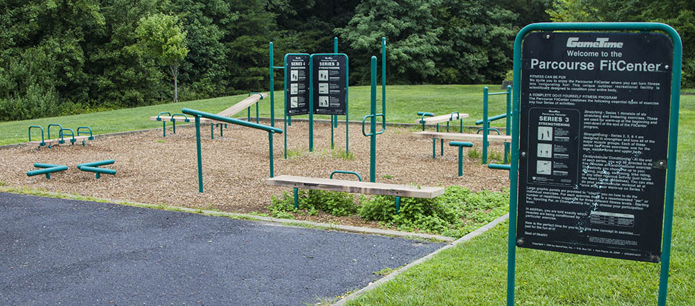 An outdoor fitness quad with various stations for different exercises.