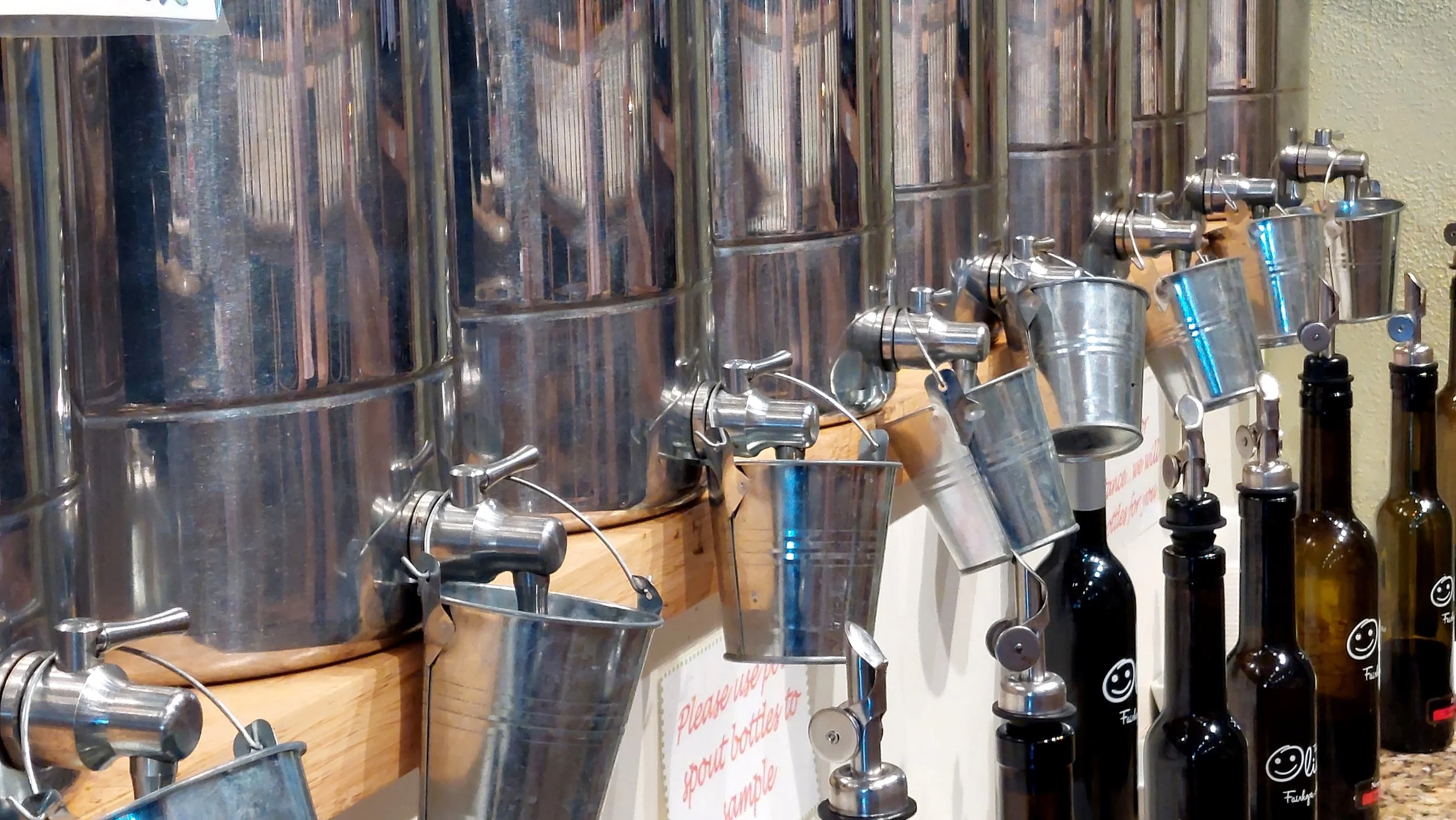  The interplay of light among unique forms dominates this simple photo of infused vinegar dispensers at The Happy Olive in Fairhope. I was particularly drawn to the many curves in the tiny bucket and their handles, and the round reservoirs. The brigh