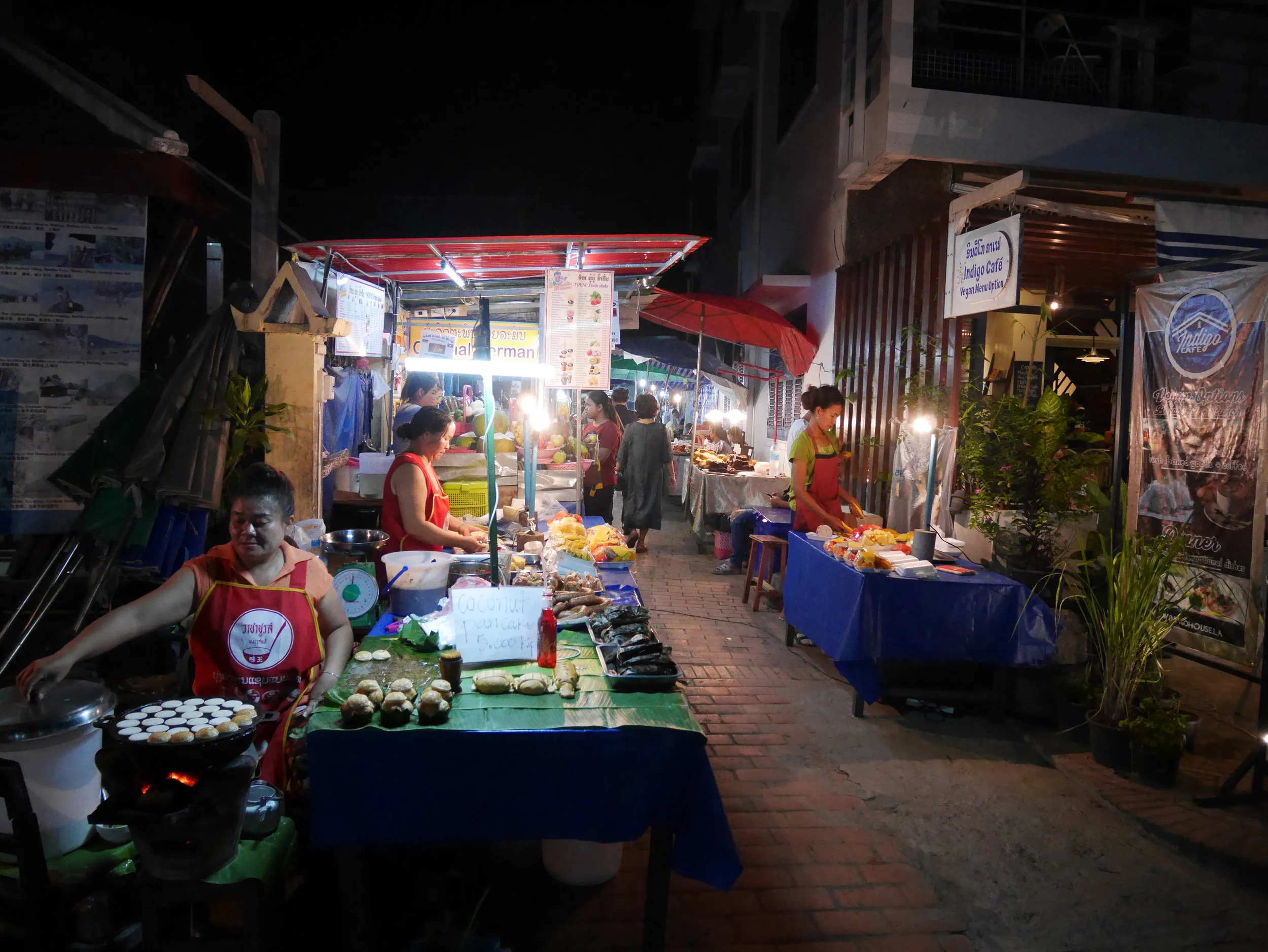 street vendors preparing food and snacks at the Night Market in Luang Prabang, Laos 