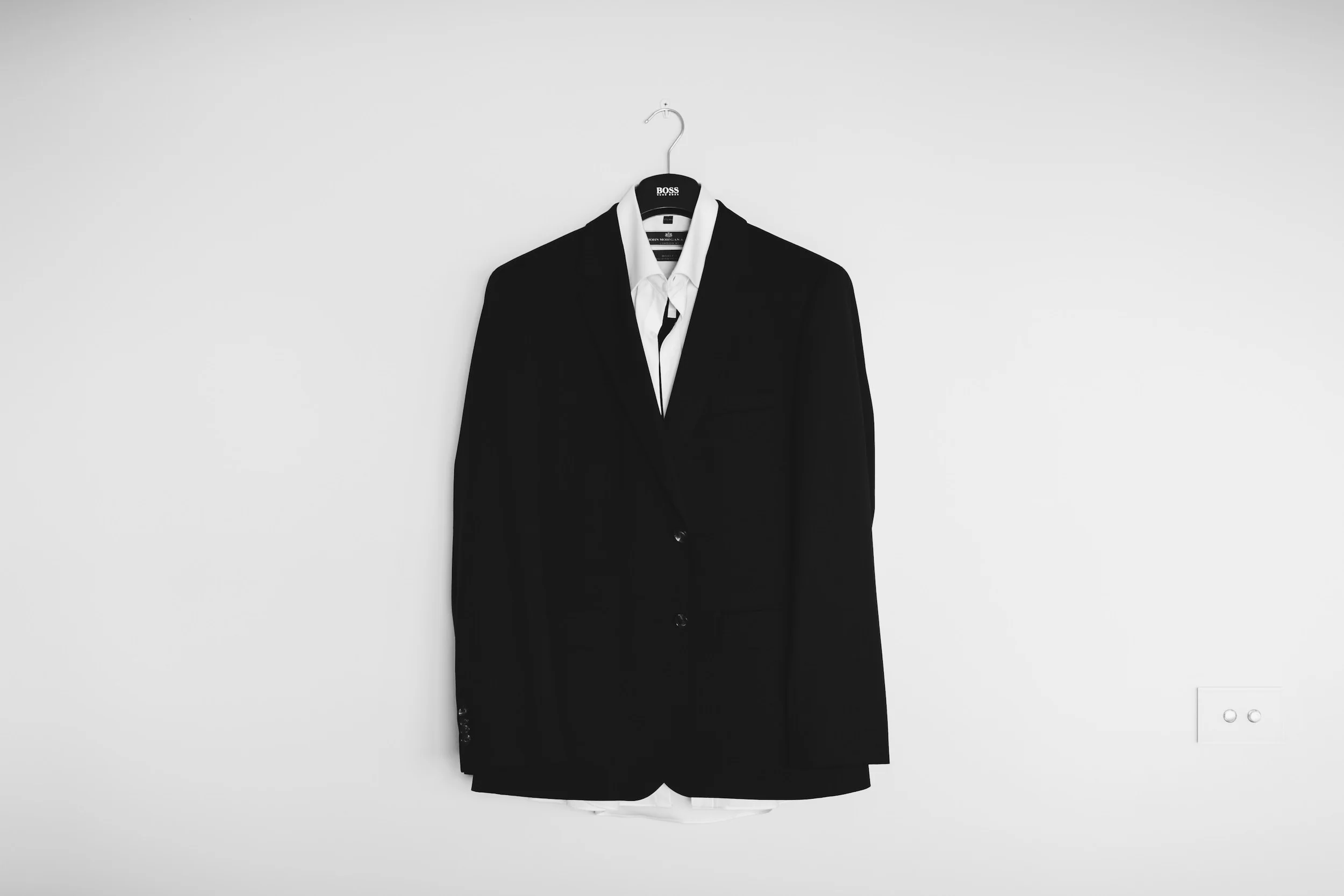 a laid out custom suit hanging on the wall