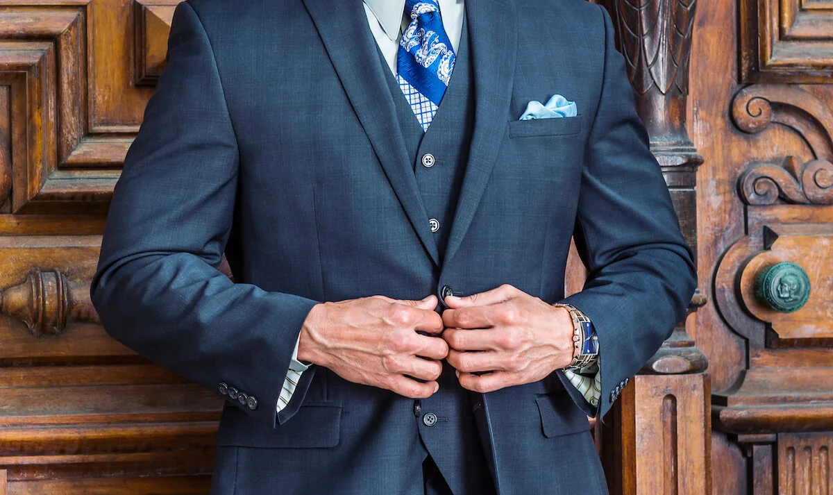 Blue gray suit with pocket square in a two pointed fold