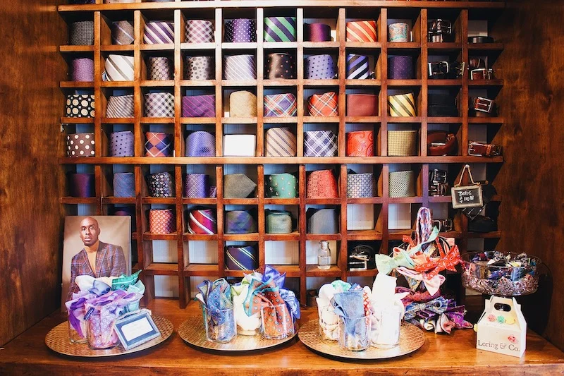 wall of ties and custom suit accessories