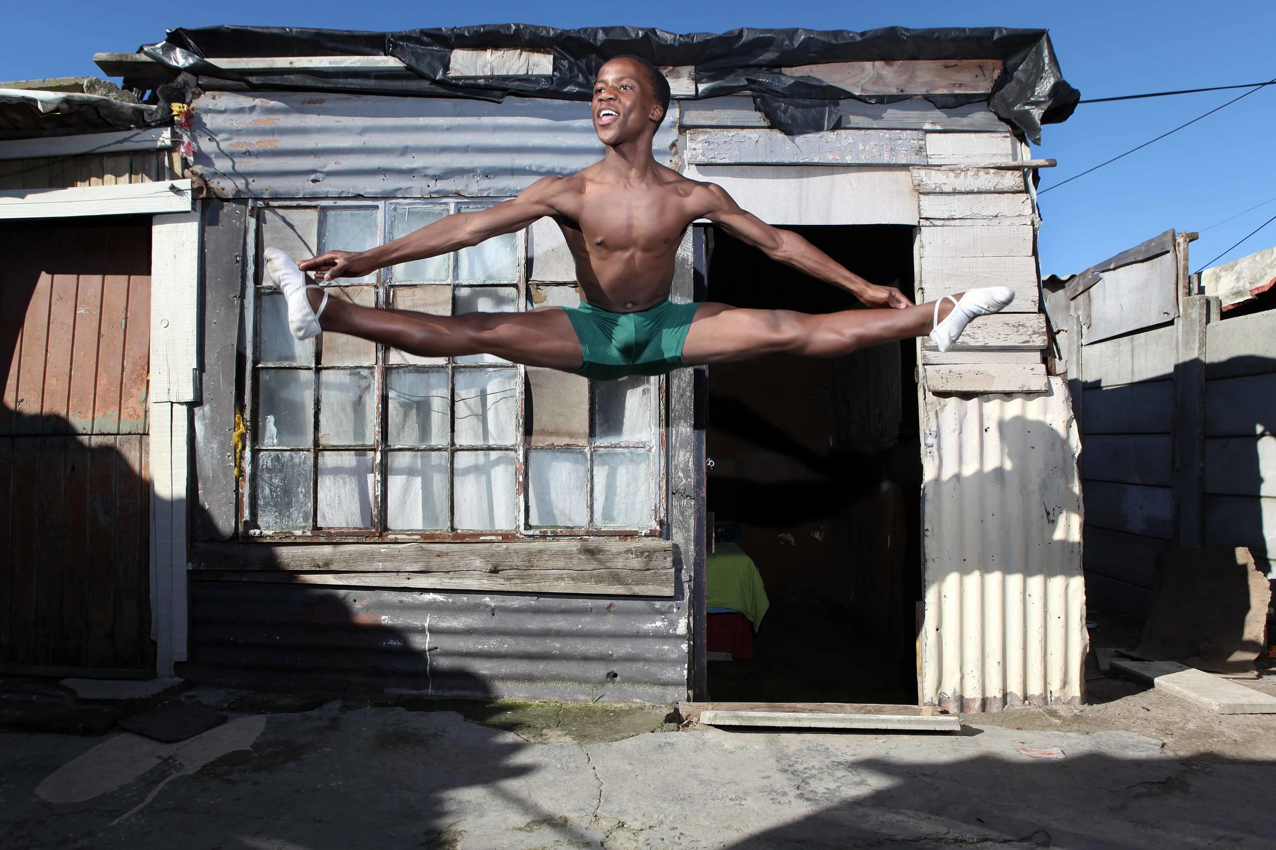 A ballet dancer in an informal community (township). Photo by Bruce Sutherland.