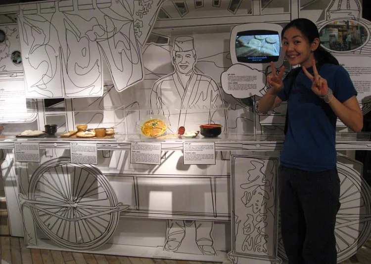 Standing proud in front of another display of Japanese dishes.