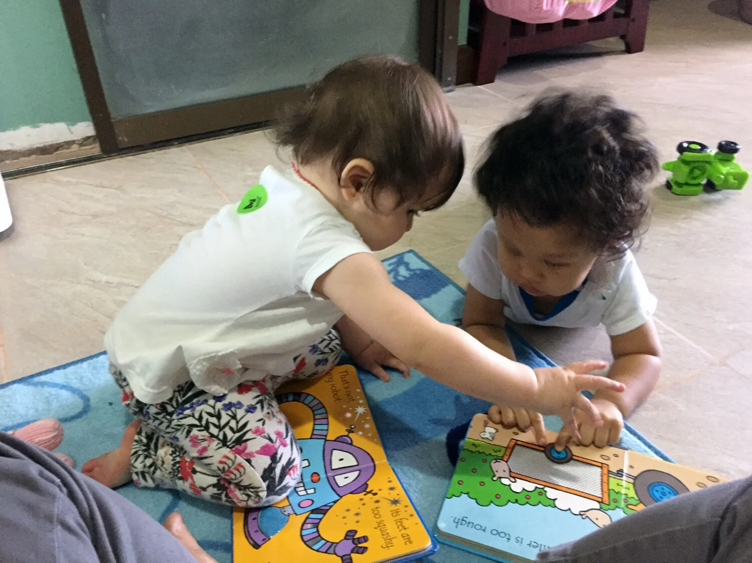 Showing Mia the wonderful wheels in her own book.