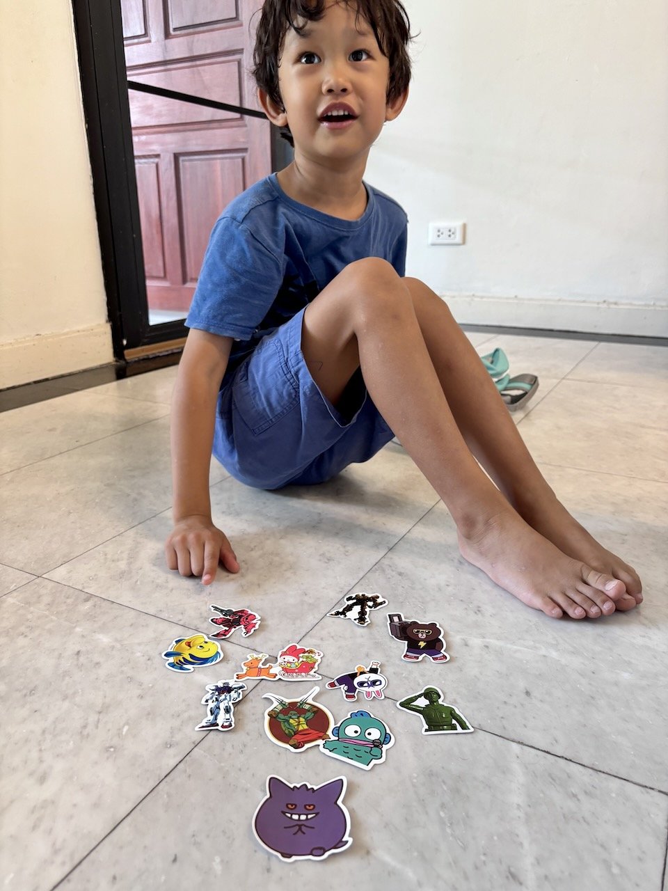 Showing off all the cool stickers he's gotten at piano class.