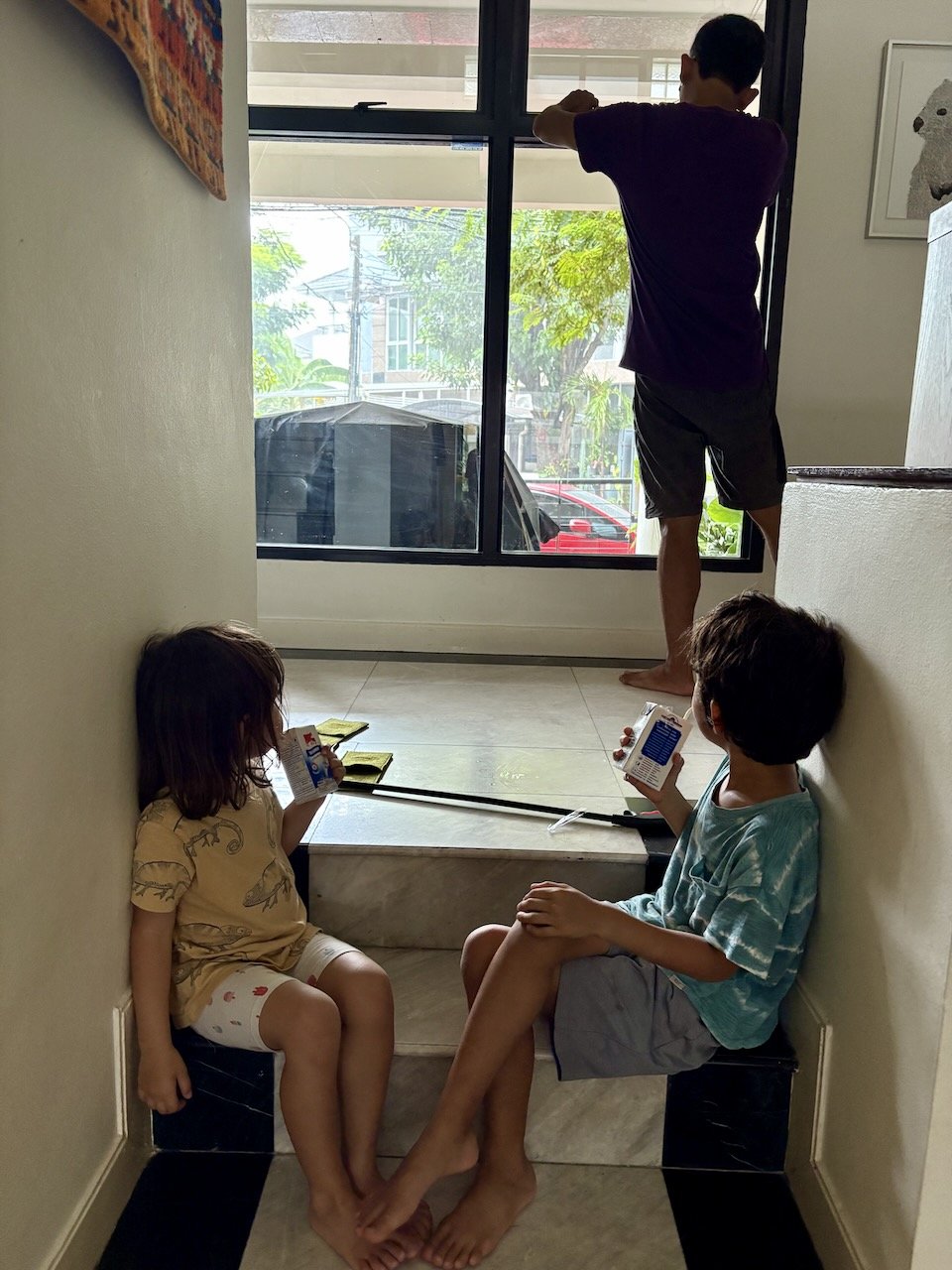 Sitting near the window and watching the rain.