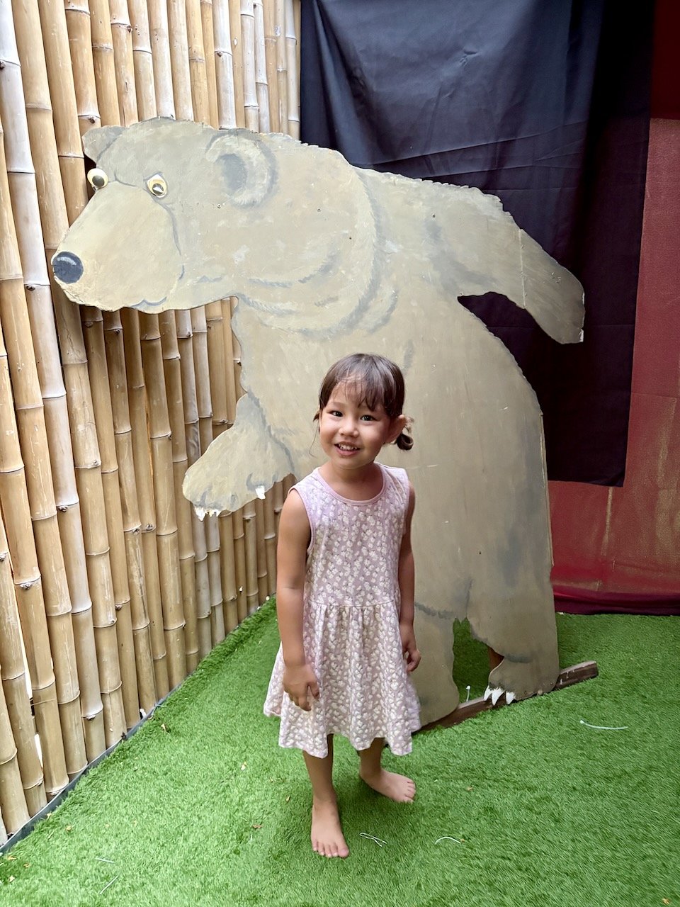 Happily posing with the giant "frightening" bear.