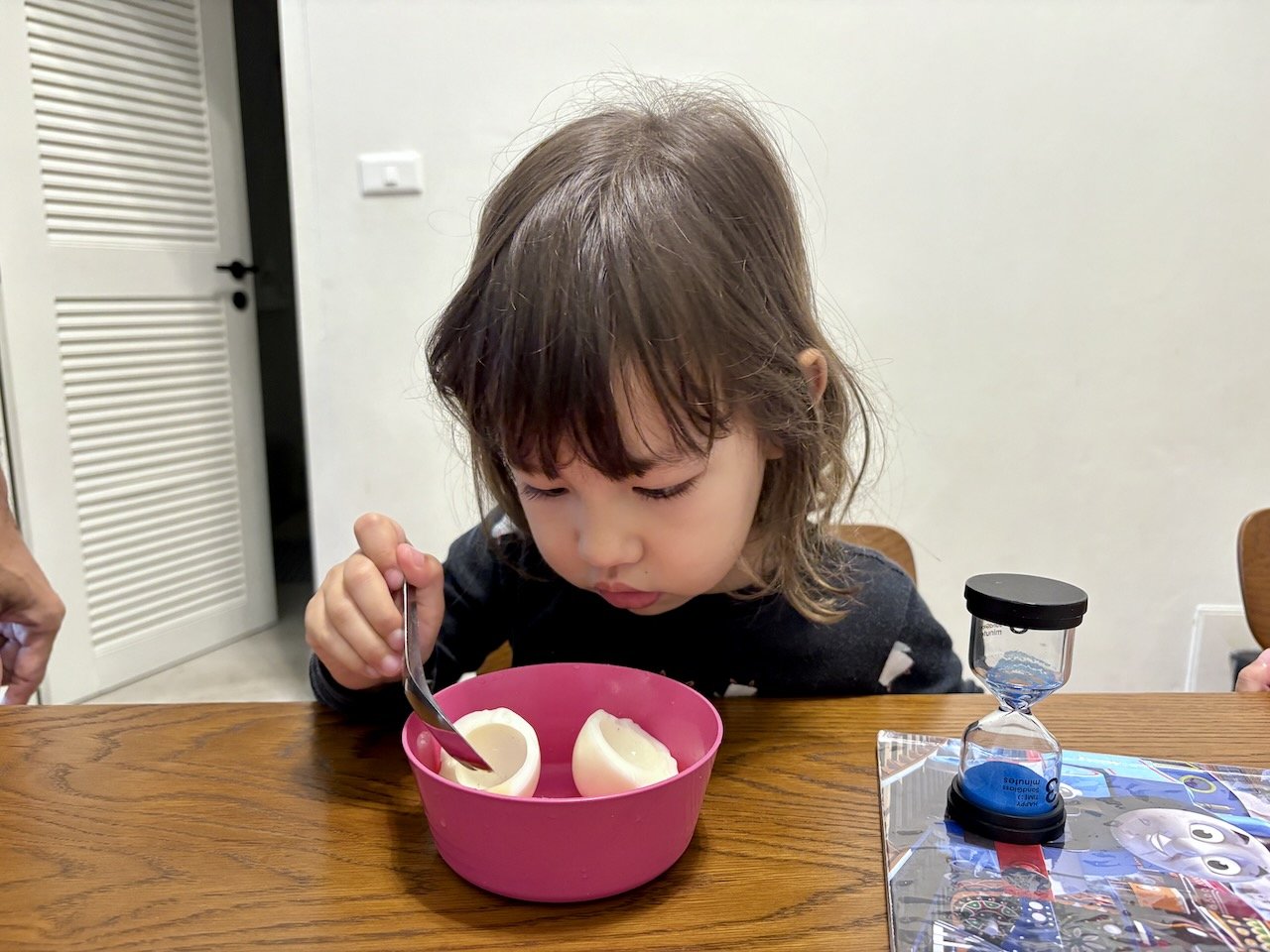 Inspecting her egg really well.
