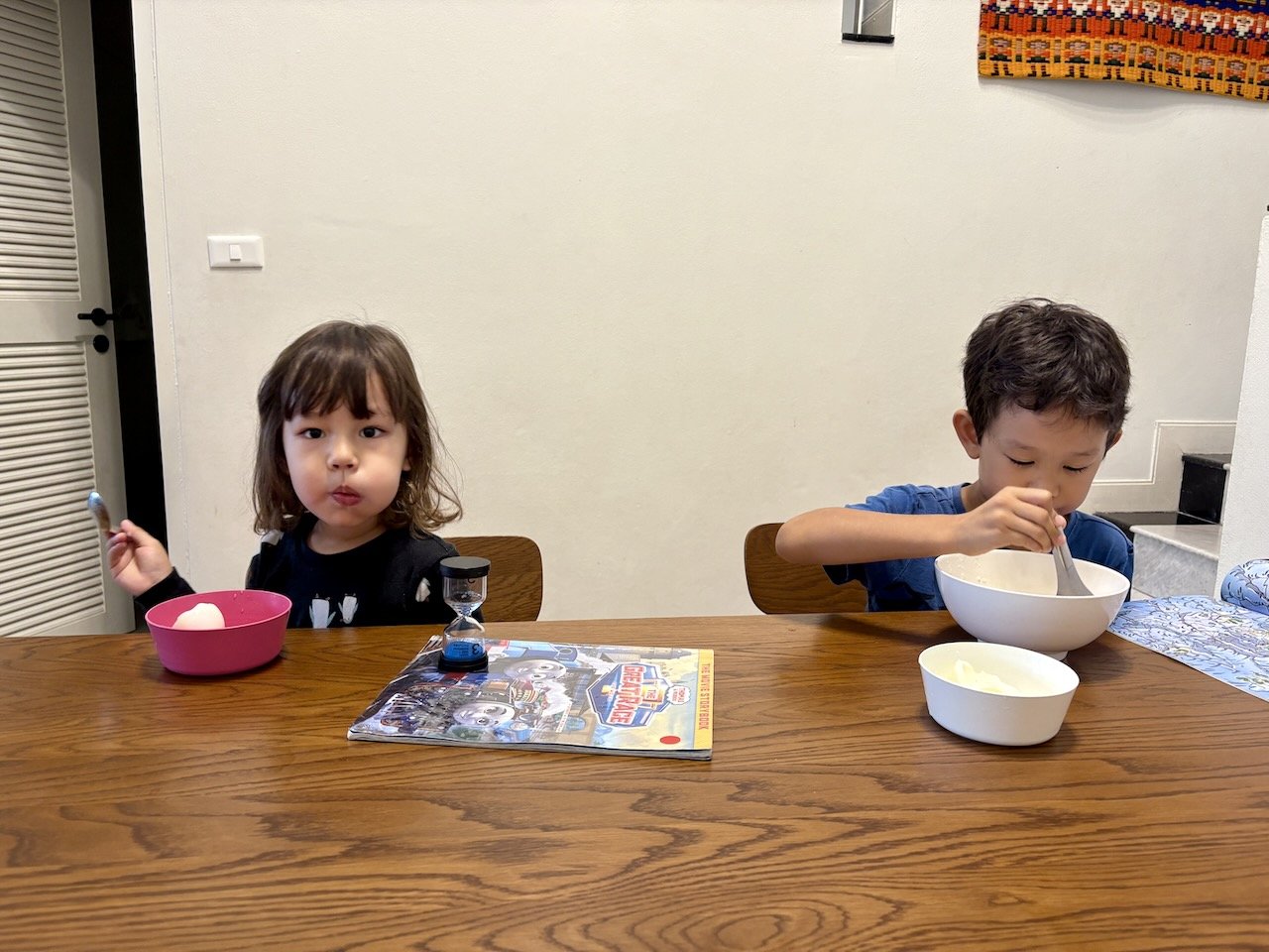 Cheek full of egg, while Arlo enjoys his joke.
