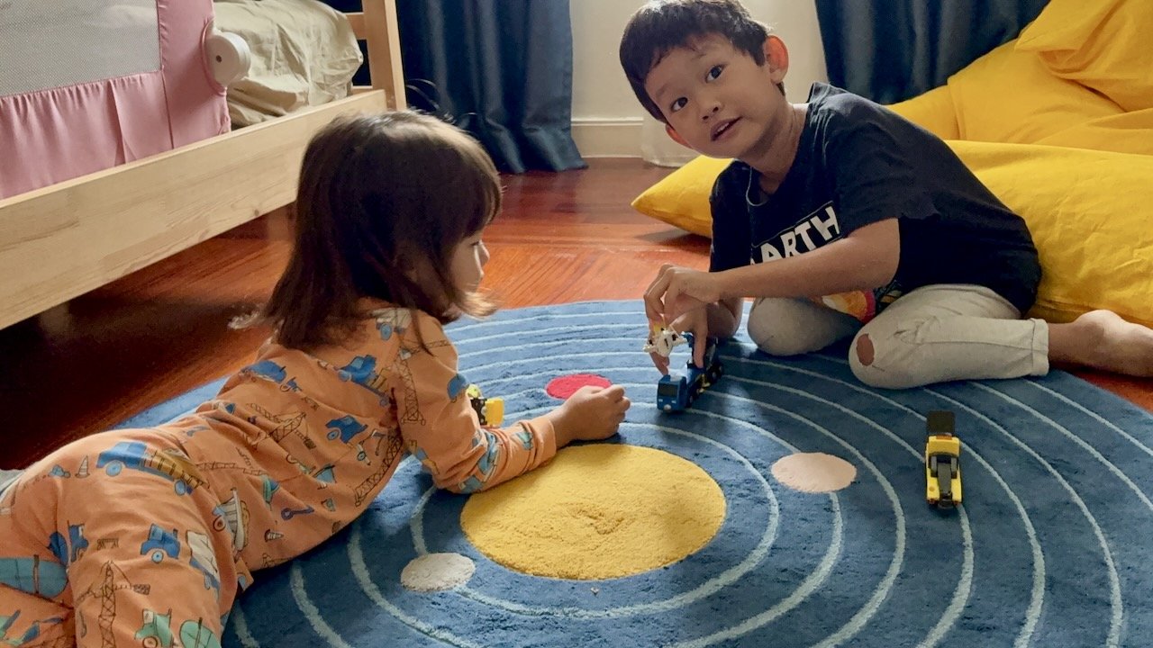 Arlo came in to help rouse his sister, and now they're playing cars.