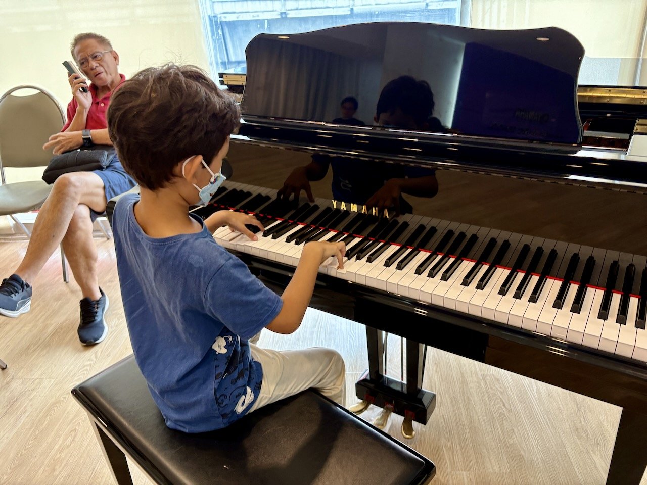 He enjoys playing the grand piano in the lobby.