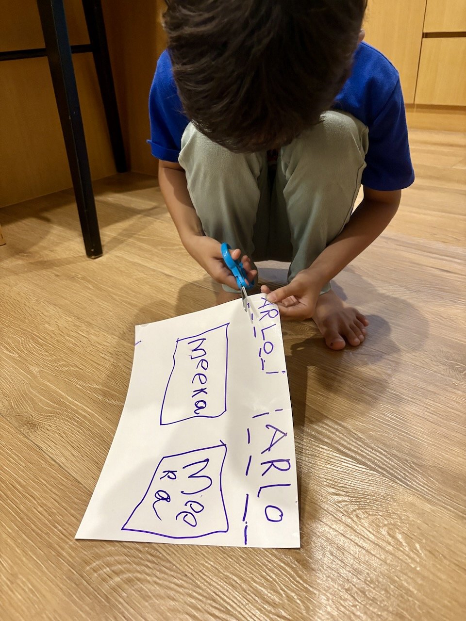 So Arlo's making the name labels himself.