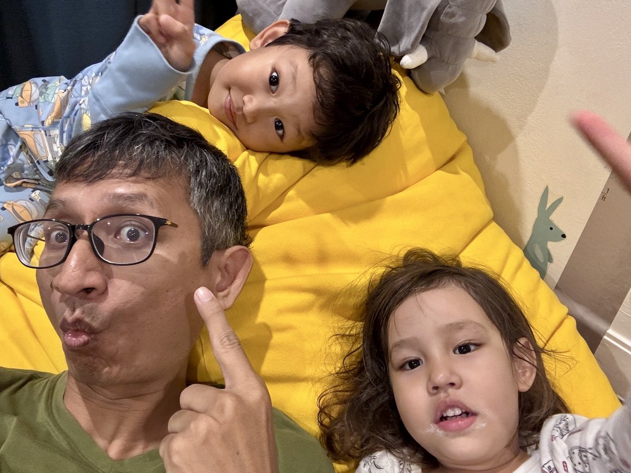 Bedtime with Dad, whose poor glasses frame just snapped mid-arm.