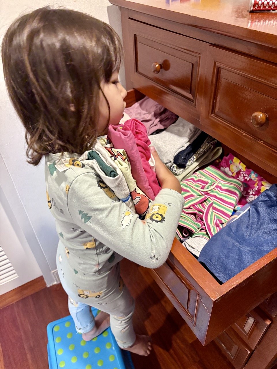 Lucy's grabbing about 5 pairs of tops, 5 bottoms, and 5 undies to bring downstairs. "I need all the things!"