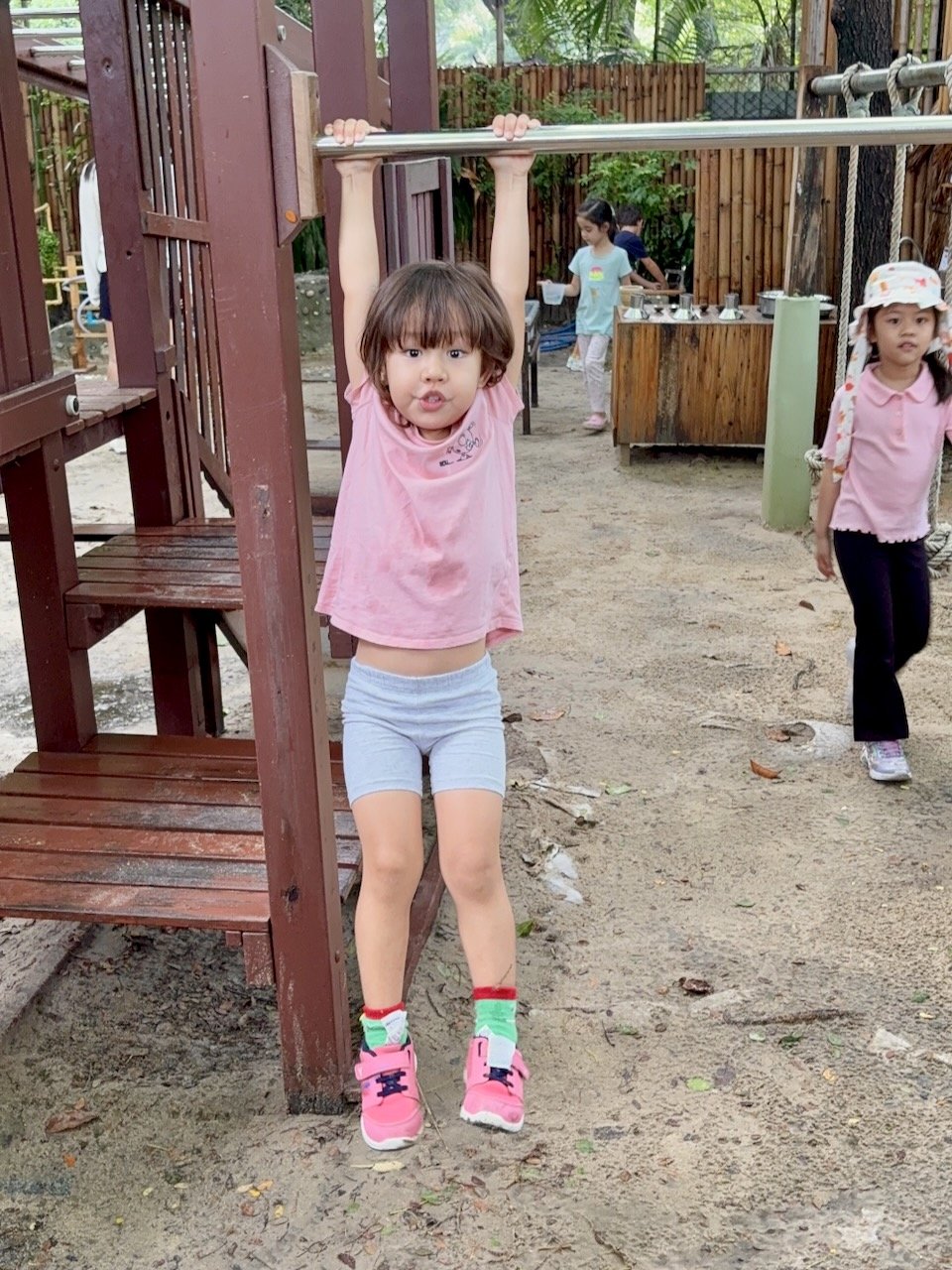 She's conquered her fears about dropping off the bar, and so can now go up and down all by herself.