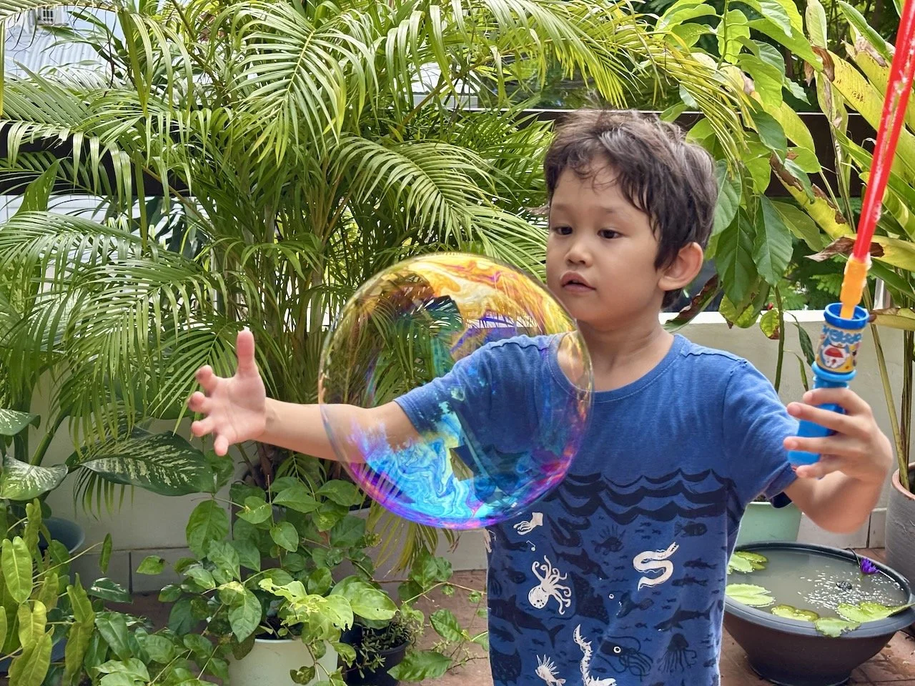Playing with their new, giant bubbles.