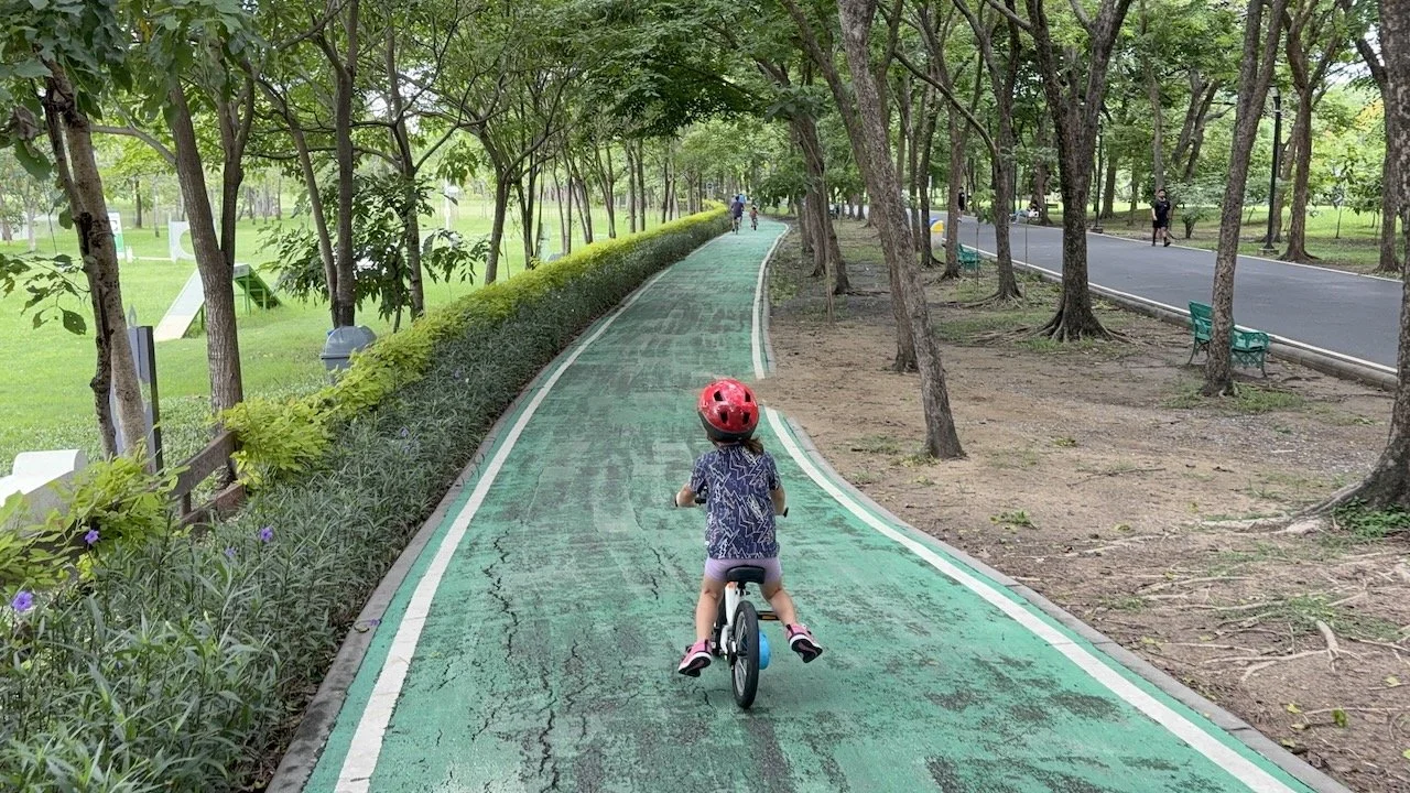 It's Lucy's first time biking by herself at Rot Fai park.