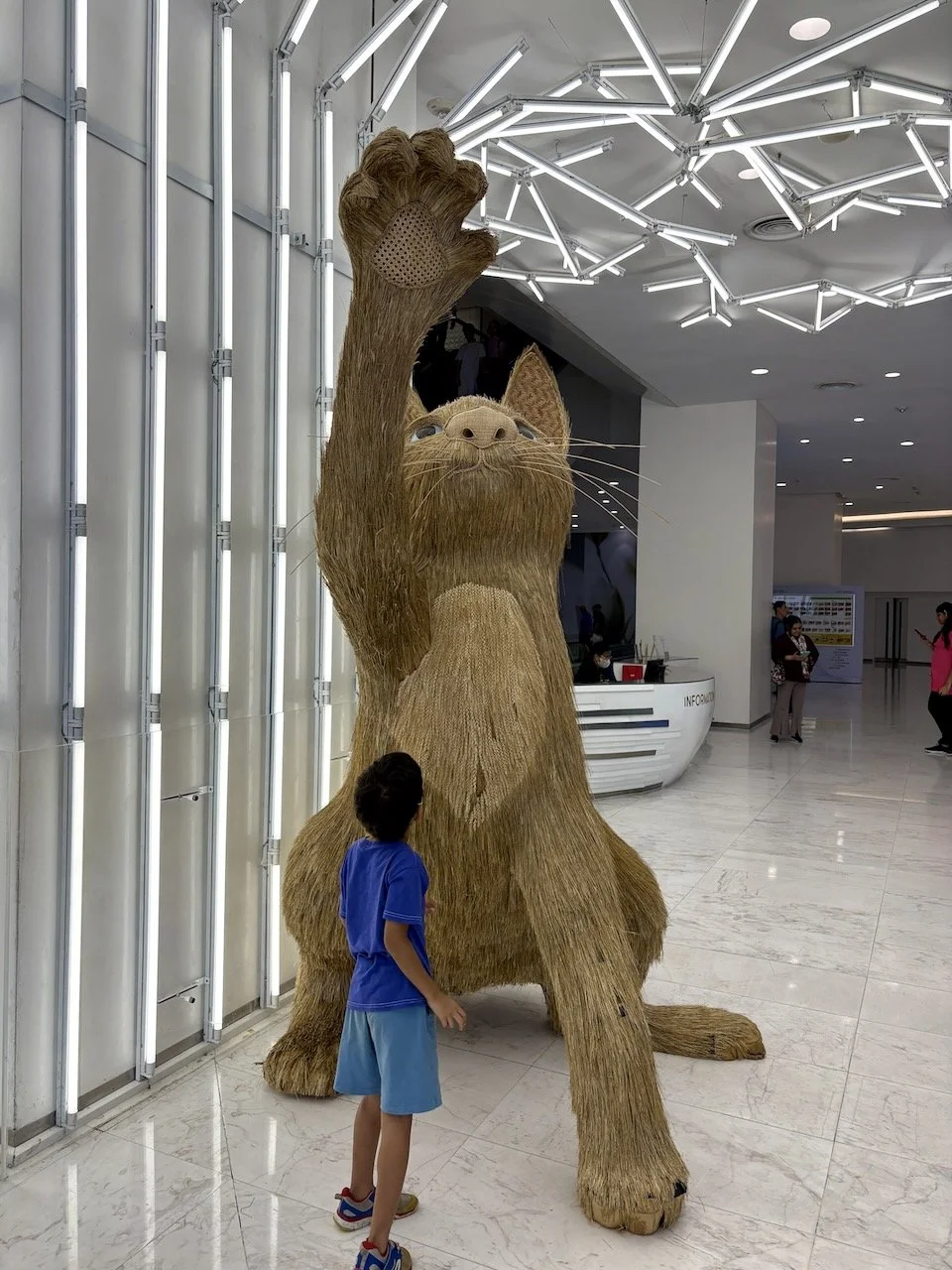Taking in the very (larger than) life-like cat in EmQuartier.