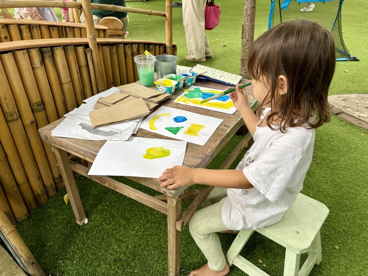 Focusing hard on her artwork.