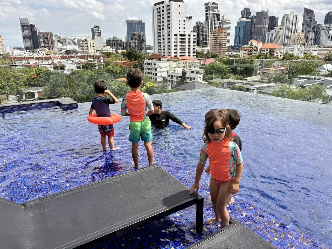 Enjoying a dip at their pool. It had a great view of our old neighborhood!