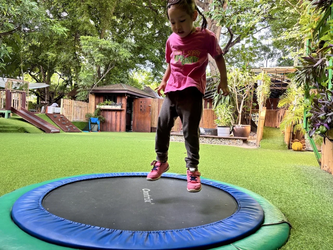 Lucy floating above the trampoline, enjoying the empty garden.