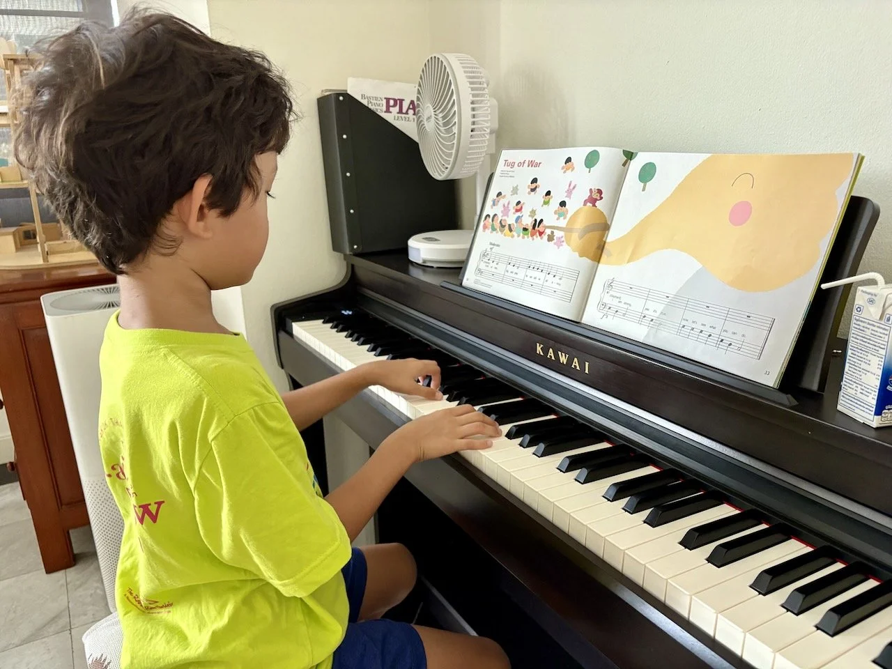 Practicing piano. It's two hands now (but not yet at the same time).