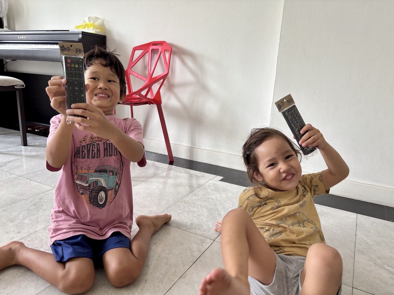 New toy from dad: TV remotes for each of them!