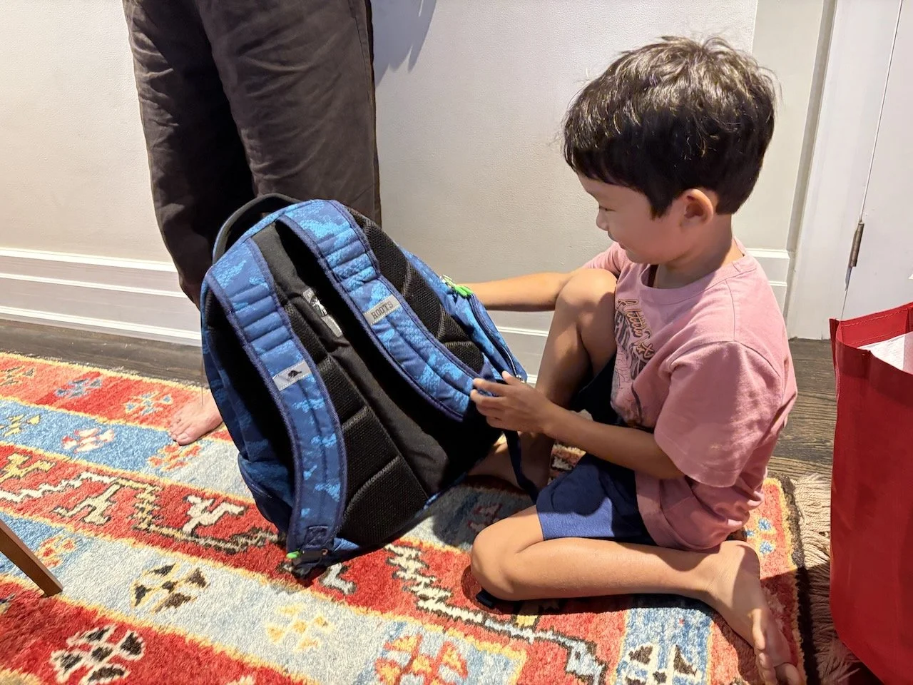 Arlo's thrilled with his new many-pocket backpack. It'll also serve him for many school years to come!