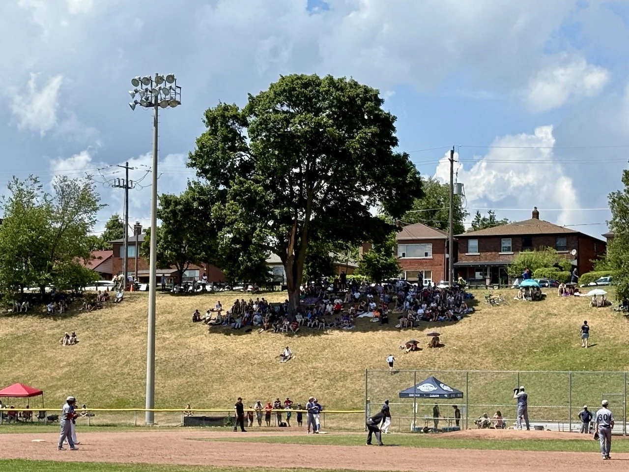 The day turned into a beautiful afternoon! Can you spot the crowds at the Christie Pitts baseball game?