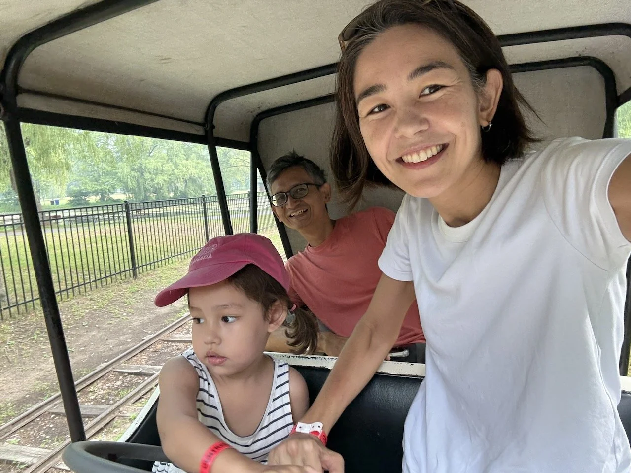 "Driving" the antique cars herself.