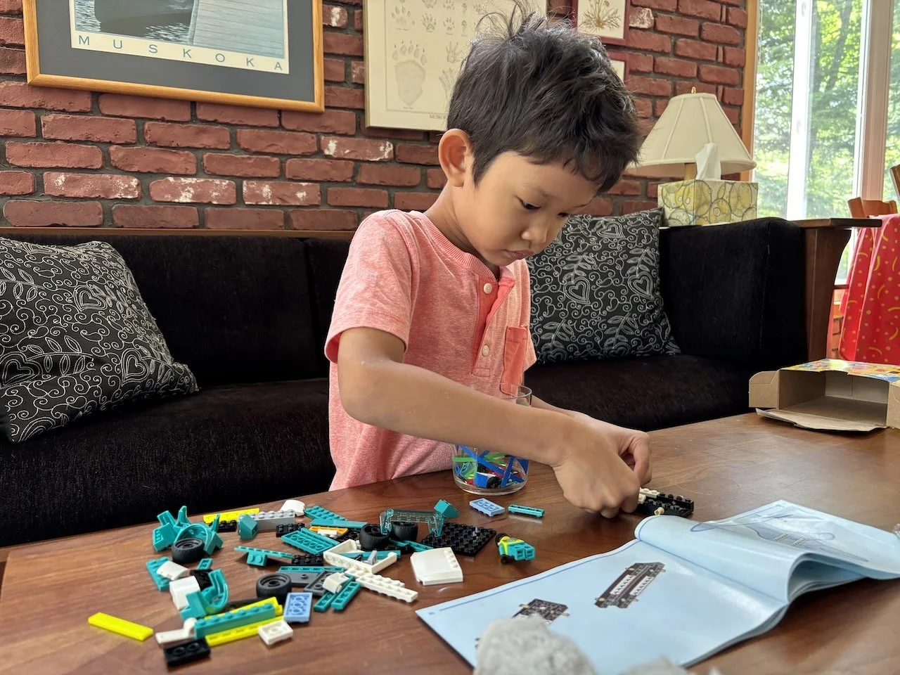 Wasting no time at all: setting out to build his new LEGO ambulance the moment we arrive.