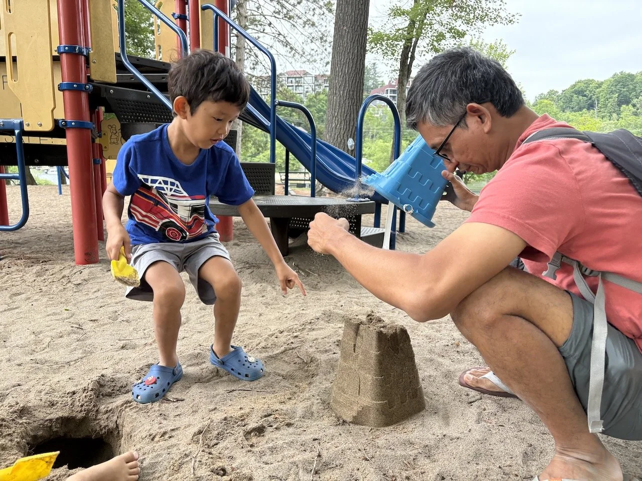 Digging the deepest holes that have probably been dug at that playground, in order to reach wet sand.