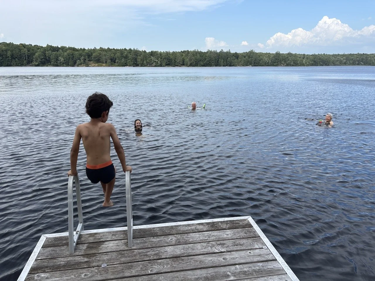 In such a hurry to swim, there's no time to change into his suit.