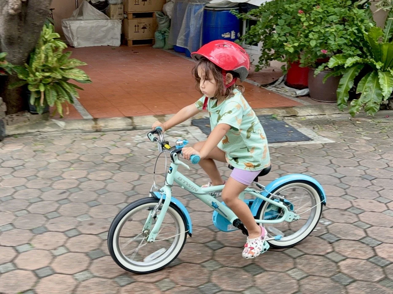 Getting practice on her new, big bike.