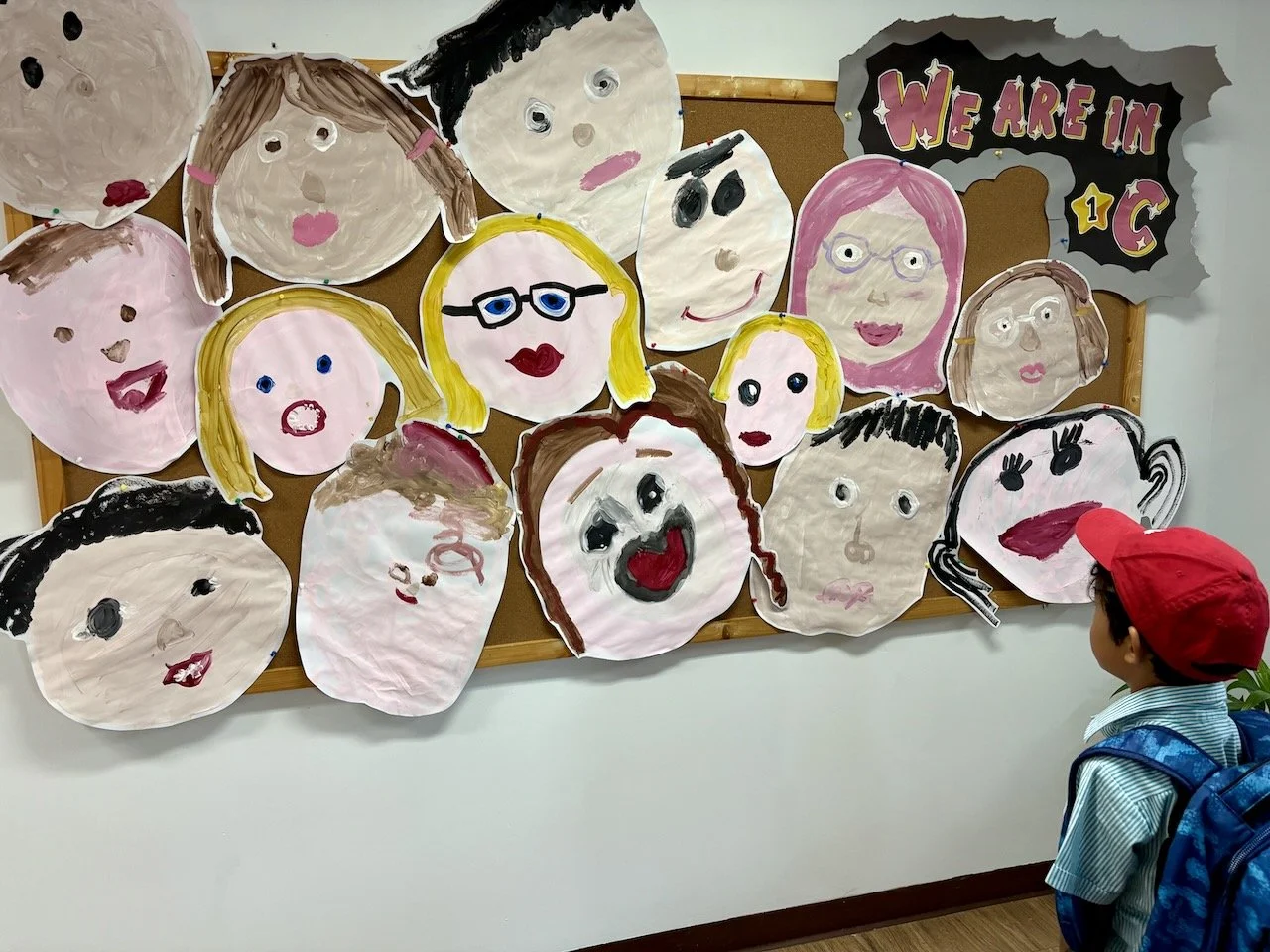 At pick-up, checking out Arlo's class's self-portraits.