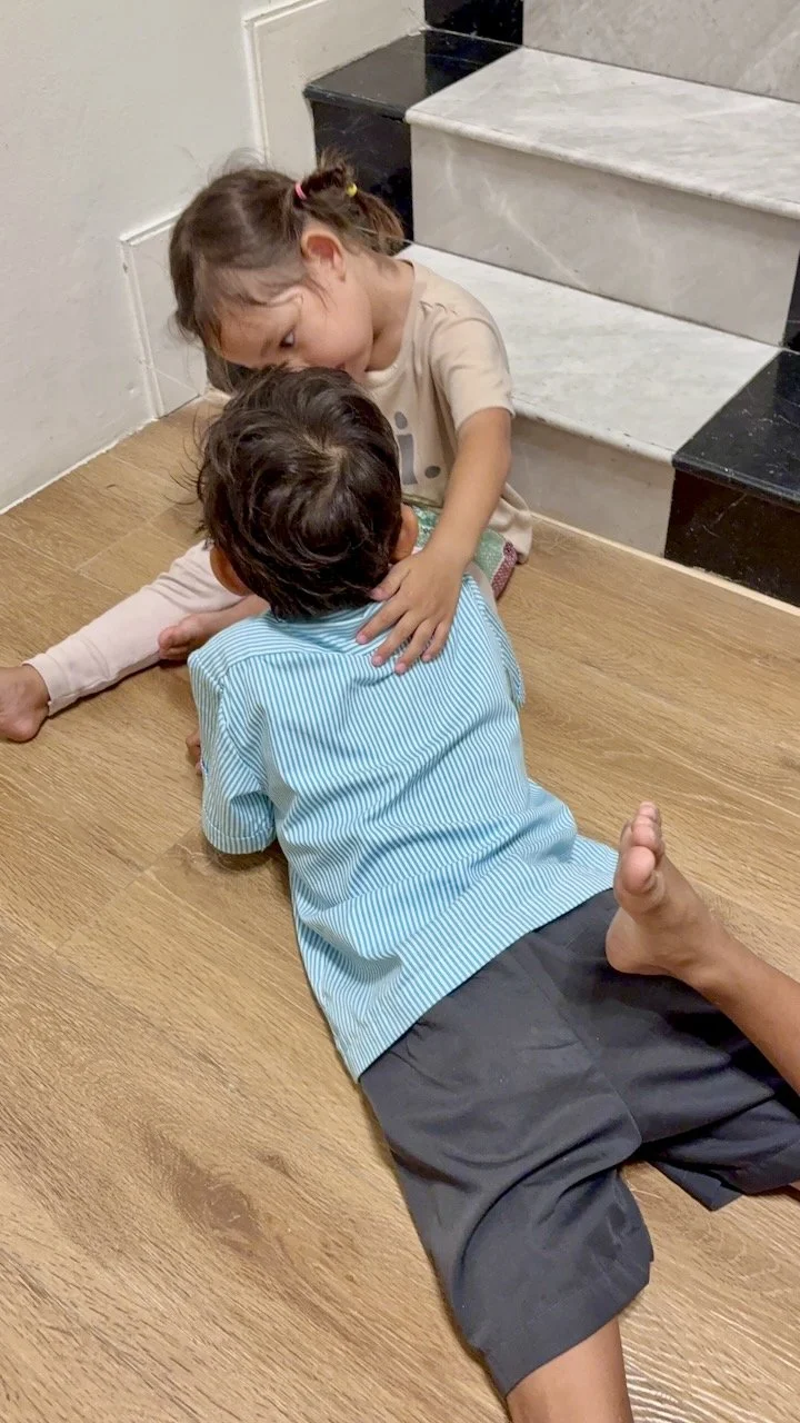 Consoling her brother.