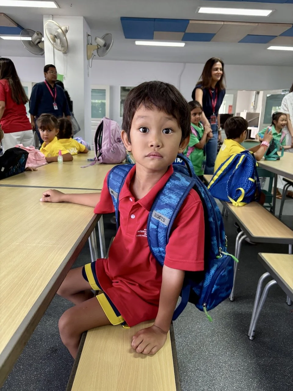 Waiting to be met by his classroom teacher.