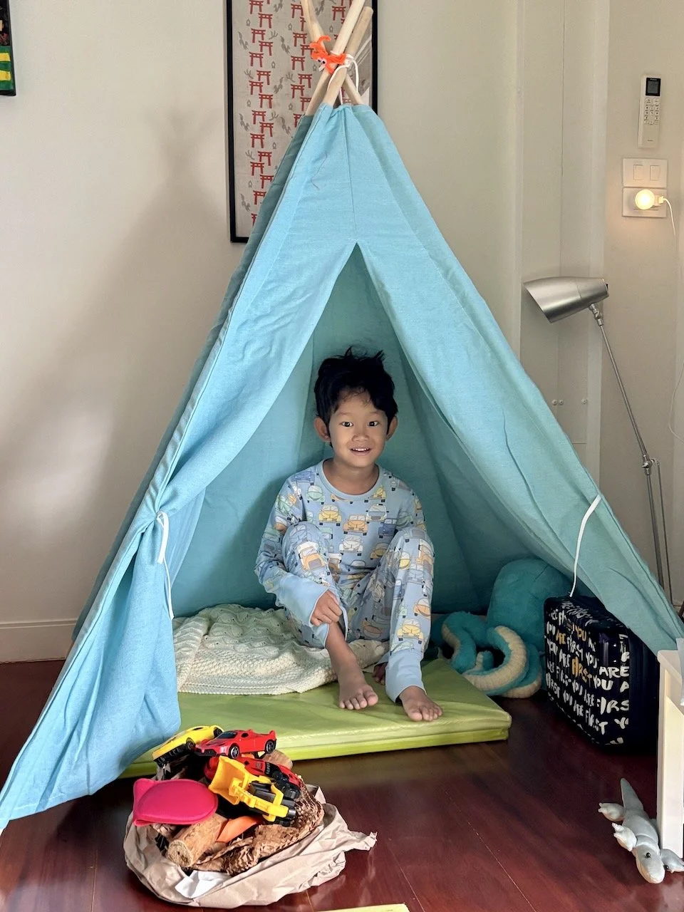 Playing camping with his new teepee on Sunday morning.