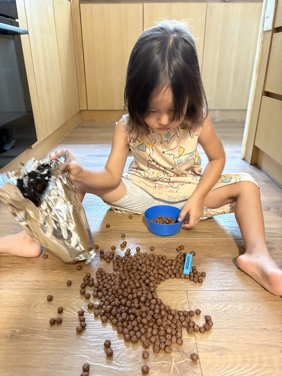 ... while Lucy takes breakfast matters into her own hands and ends up with a bit of a mess on the floor.