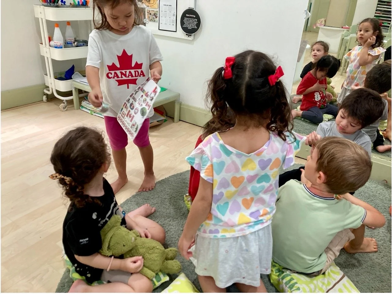 Giving out Canada stickers to her classmates.