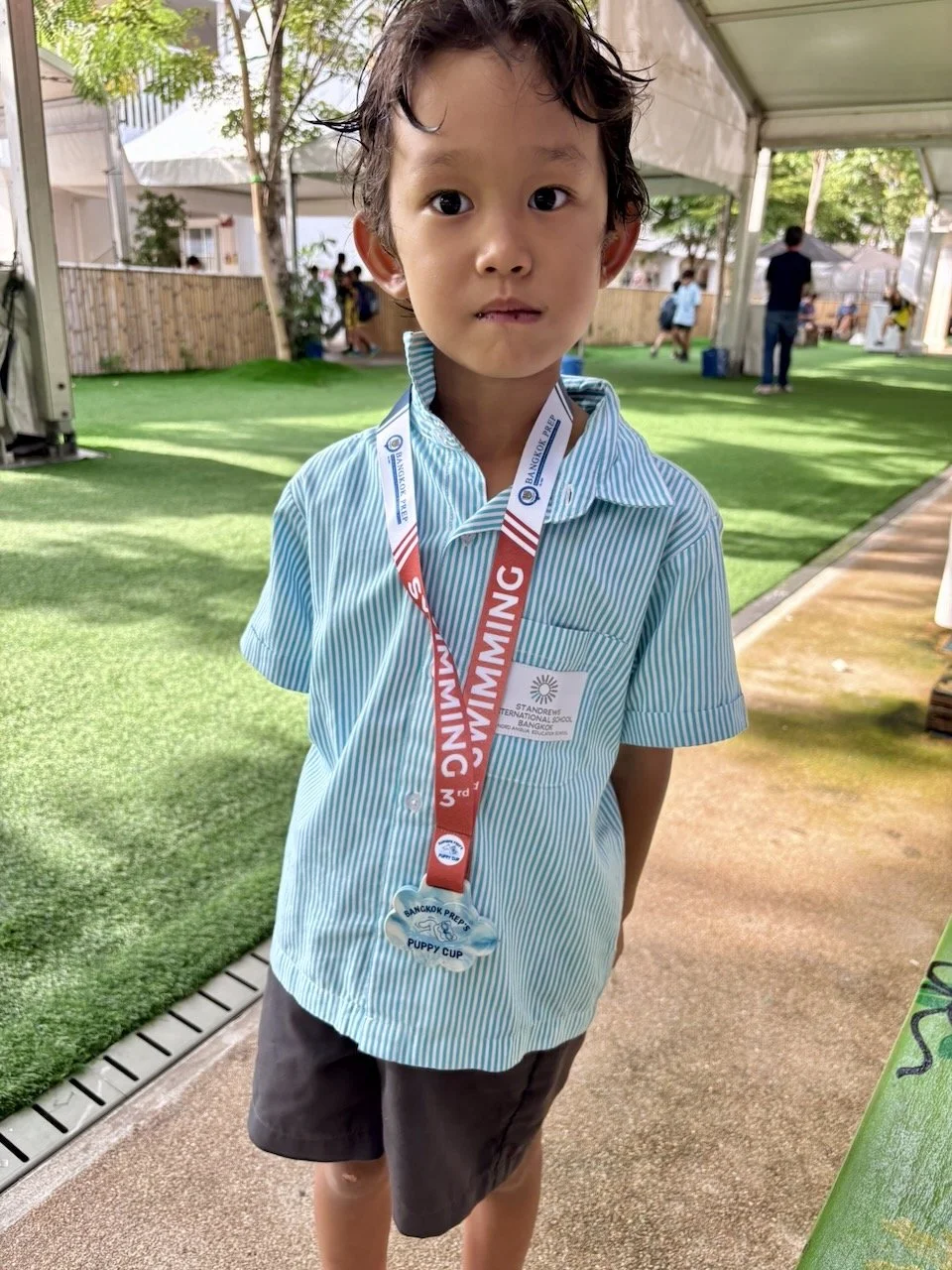 Got his (surprise) medal from Coach Goh at swimming on Wednesday.