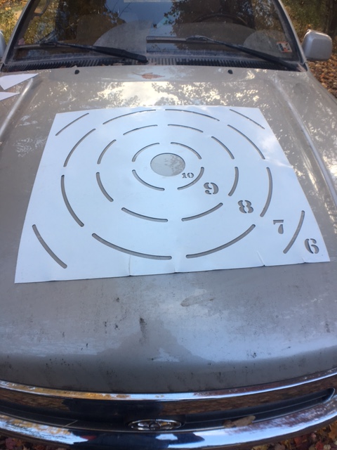 I keep a stencil on the hood of my range truck for a couple reasons - convenience, and in cold weather the engine heat softens the material. Don't do this if you care about your paint!