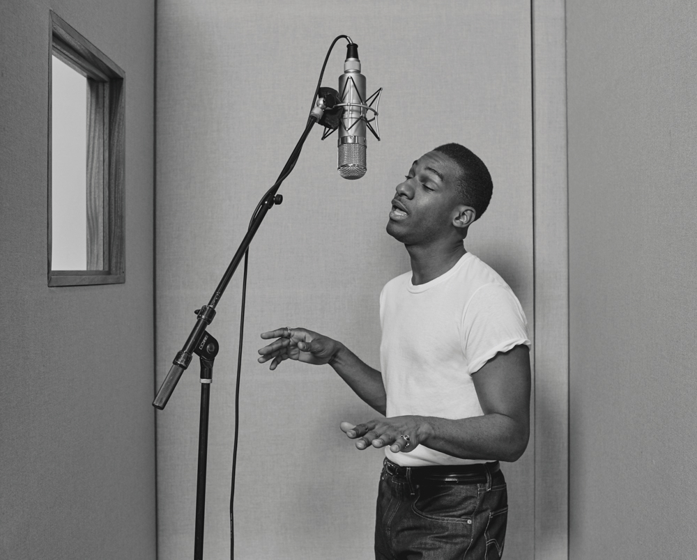 Leon Bridges in the vocal booth singing into a vintage Neumann U47
