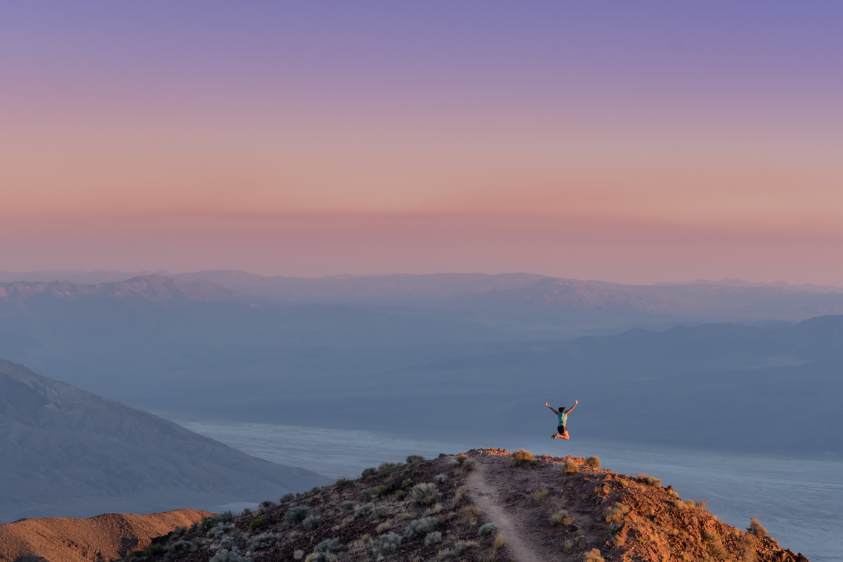 Woman Leaps at Sunset in Death Valley Mountains
