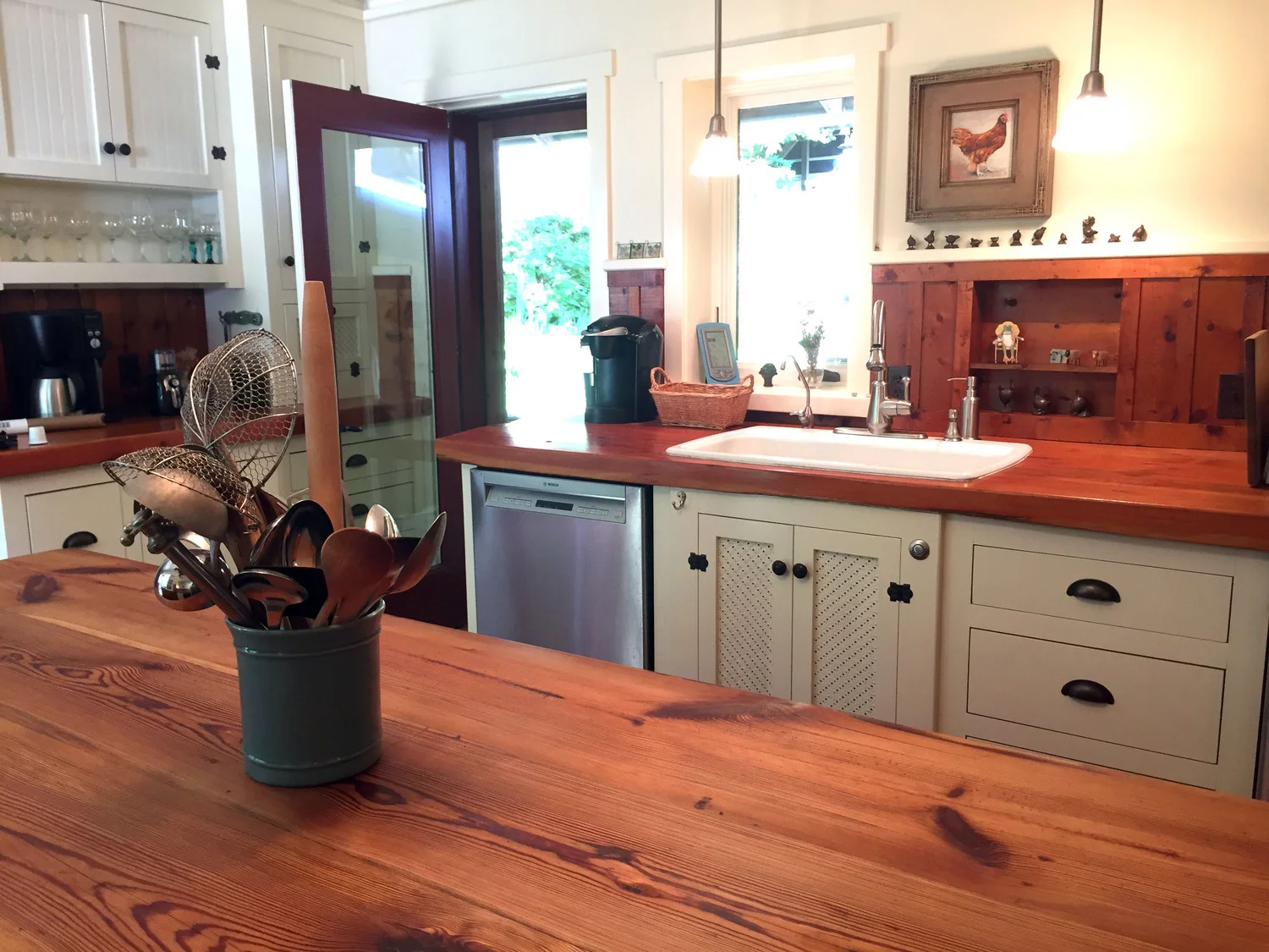 The kitchen sink area and door out to the pizza oven