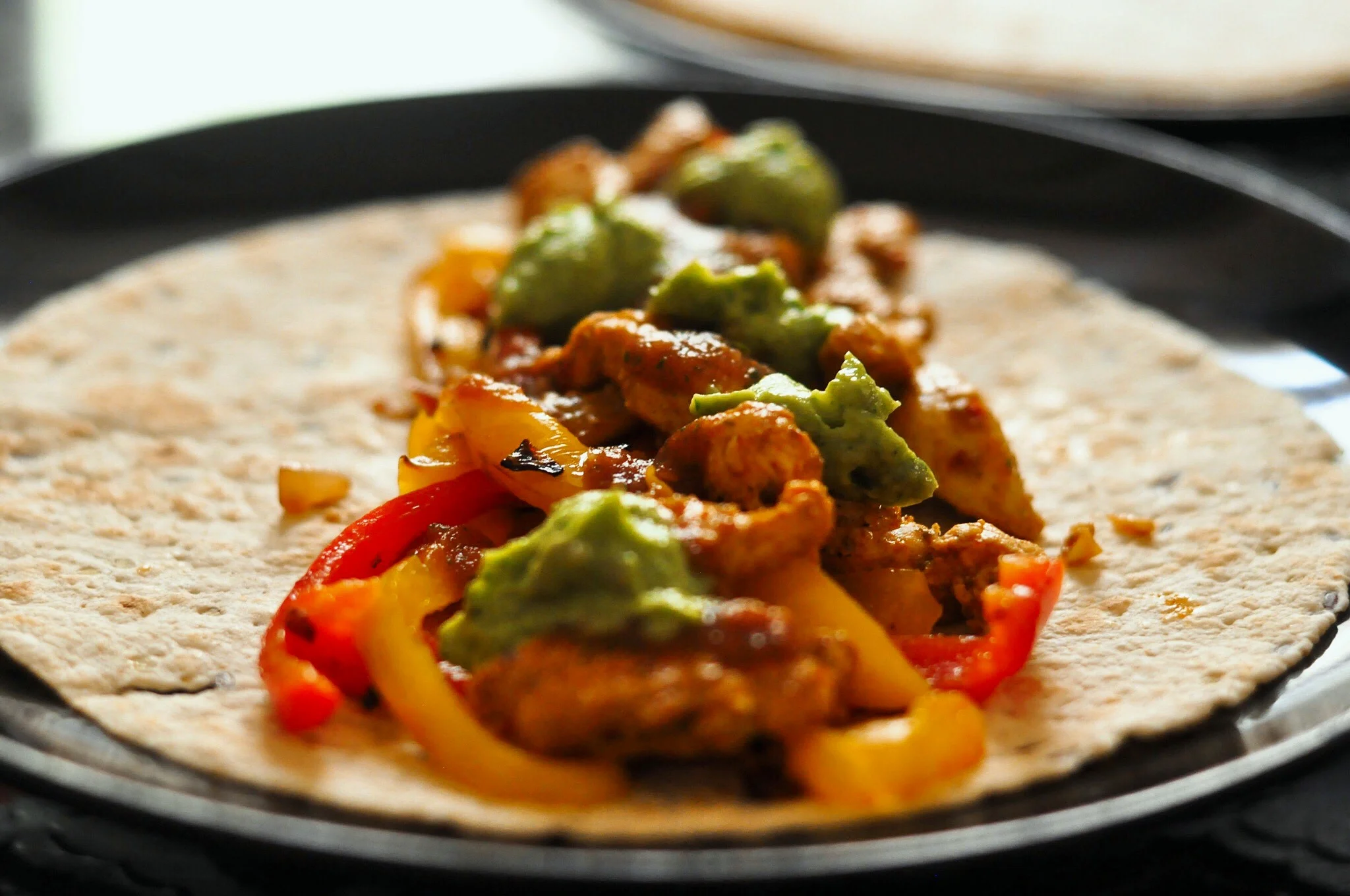 Chicken fajitas with tomato salsa and avocado cream